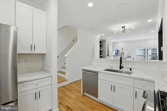 2127 12th Pl NW, Washington, DC 20009 - kitchen featuring stainless steel appliances, white cabinets, light wood-style flooring, light stone counters, and recessed lighting