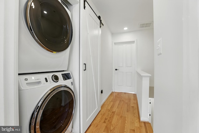 2127 12th Pl NW, Washington, DC 20009 - laundry room featuring stacked washer and clothes dryer, light wood-style floors, and recessed lighting