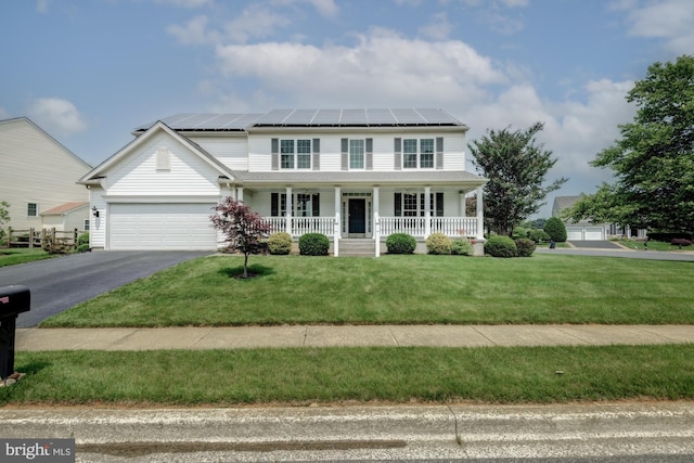 213 Casper Way, Middletown, DE 19709 - traditional-style house featuring a porch, roof mounted solar panels, an attached garage, driveway, and a front lawn