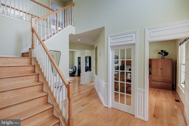 213 Casper Way, Middletown, DE 19709 - staircase featuring wood finished floors, a towering ceiling, and wainscoting