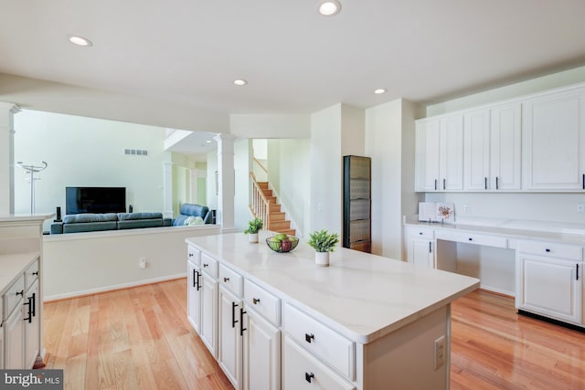 213 Casper Way, Middletown, DE 19709 - kitchen with decorative columns, light wood-style flooring, white cabinets, a kitchen island, and recessed lighting