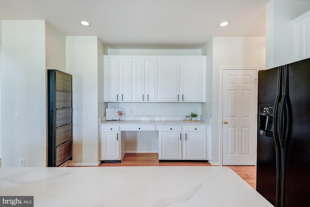 213 Casper Way, Middletown, DE 19709 - kitchen with black fridge, white cabinetry, light stone counters, light wood-type flooring, and recessed lighting