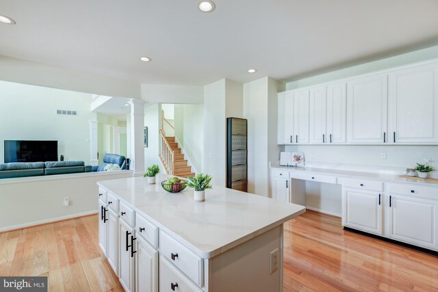 213 Casper Way, Middletown, DE 19709 - kitchen with ornate columns, white cabinetry, light wood-type flooring, a kitchen island, and recessed lighting