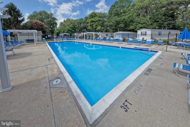 19940 4th Ave, Rehoboth Beach, DE 19971 - community pool with a patio and view of wooded area
