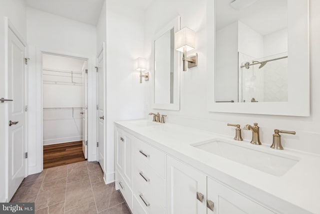 19712 Crows Nest Ct, Georgetown, DE 19947 - bathroom featuring double vanity, tiled shower, and a walk in closet