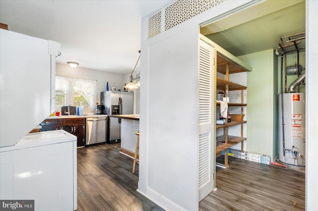 8413 Hallmark Cir, Baltimore, MD 21234 - kitchen with water heater, stainless steel appliances, dark wood-style floors, washer / dryer, and light countertops