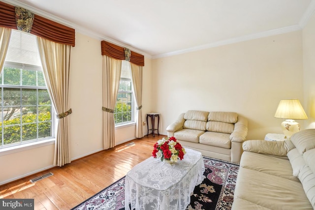 2363 Ashford Dr, Waldorf, MD 20603 - living area with crown molding, healthy amount of natural light, and wood finished floors