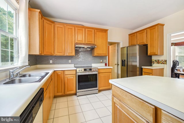 2363 Ashford Dr, Waldorf, MD 20603 - kitchen featuring stainless steel appliances, under cabinet range hood, tasteful backsplash, light countertops, and light tile patterned floors