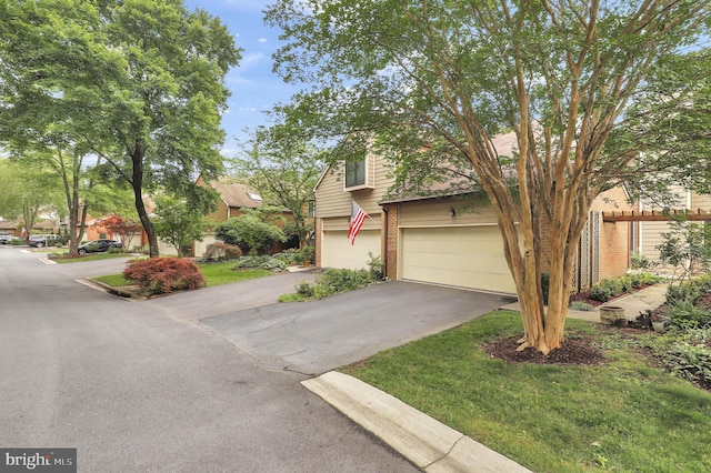 6430 Wishbone Ter, Cabin John, MD 20818 - view of property hidden behind natural elements with asphalt driveway, brick siding, and a garage