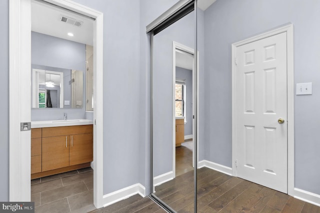 6430 Wishbone Ter, Cabin John, MD 20818 - bathroom featuring vanity, plenty of natural light, and wood finished floors