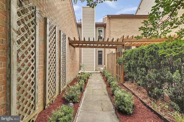 6430 Wishbone Ter, Cabin John, MD 20818 - property entrance featuring brick siding and a pergola