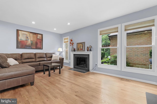 6430 Wishbone Ter, Cabin John, MD 20818 - living room with light wood-style floors, recessed lighting, and a fireplace with flush hearth
