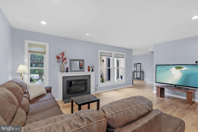 6430 Wishbone Ter, Cabin John, MD 20818 - living area with a fireplace with flush hearth, wood finished floors, and recessed lighting