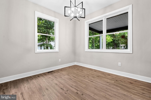 2725 S Sunset Ave, Williamstown, NJ 08094 - spare room with plenty of natural light, a chandelier, and wood finished floors