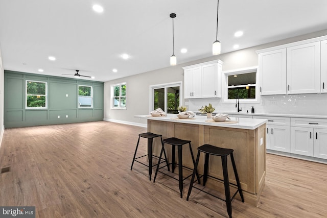 2725 S Sunset Ave, Williamstown, NJ 08094 - kitchen featuring a kitchen island, light wood-style floors, open floor plan, recessed lighting, and white cabinetry