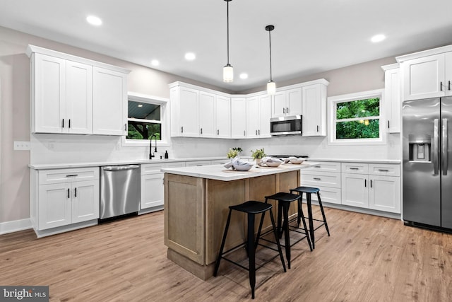 2725 S Sunset Ave, Williamstown, NJ 08094 - kitchen with appliances with stainless steel finishes, light wood finished floors, white cabinetry, and recessed lighting