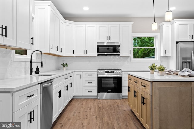 2725 S Sunset Ave, Williamstown, NJ 08094 - kitchen featuring appliances with stainless steel finishes, backsplash, light wood finished floors, white cabinets, and recessed lighting