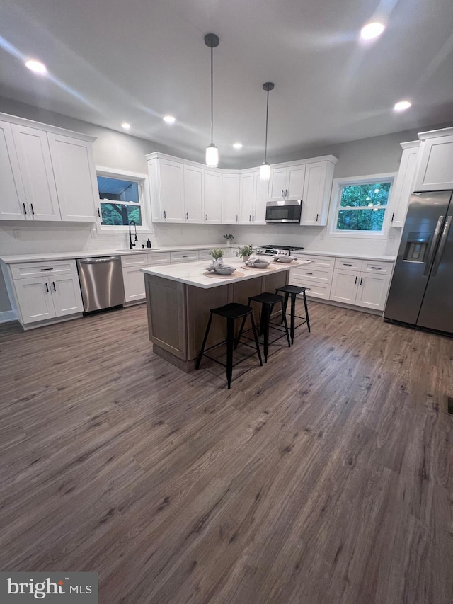 2725 S Sunset Ave, Williamstown, NJ 08094 - kitchen with stainless steel appliances, white cabinets, recessed lighting, and a kitchen bar