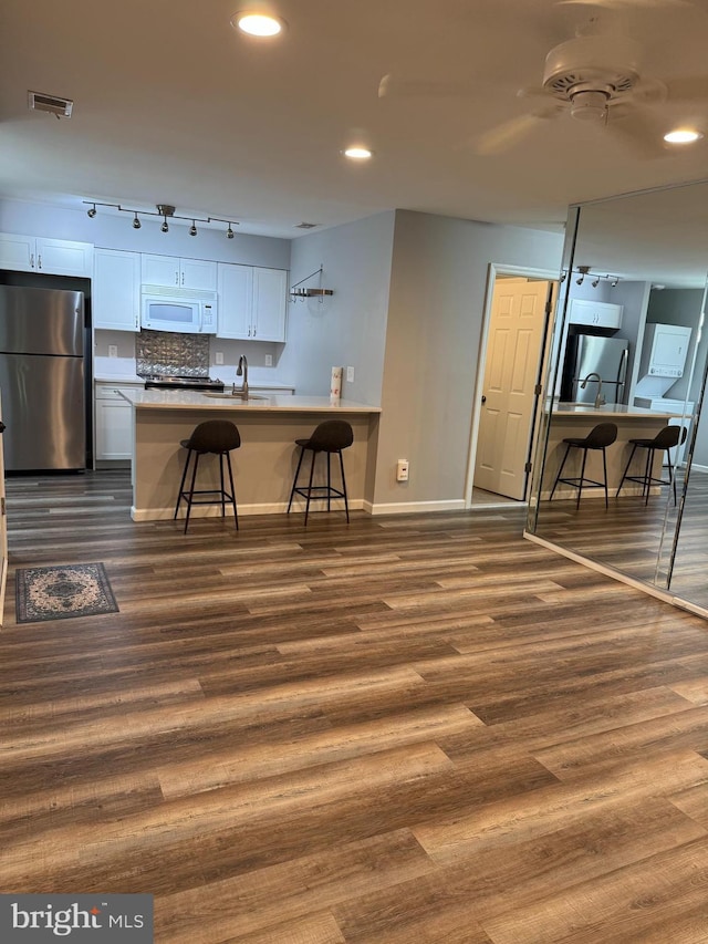 225 Barclay Ct, West Deptford, NJ 08051 - kitchen featuring freestanding refrigerator, white microwave, baseboards, a kitchen breakfast bar, and recessed lighting