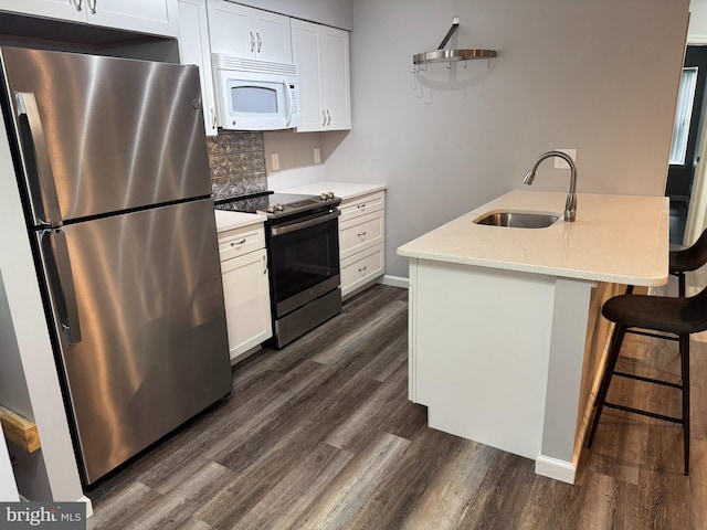 225 Barclay Ct, West Deptford, NJ 08051 - kitchen featuring stainless steel appliances, a sink, dark wood finished floors, tasteful backsplash, and white cabinetry