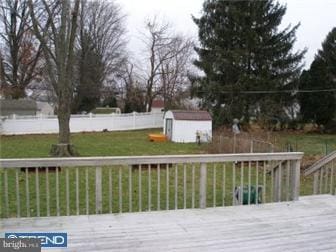 wooden terrace with a storage shed