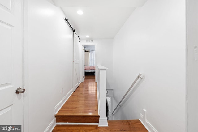 1228 S 22nd St, Philadelphia, PA 19146 - stairway with a barn door, wood finished floors, and recessed lighting