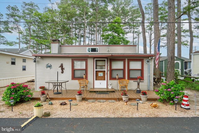 8 Clam Rd Unit 13891, Millsboro, DE 19966 - view of front of home with a wooden deck and a chimney