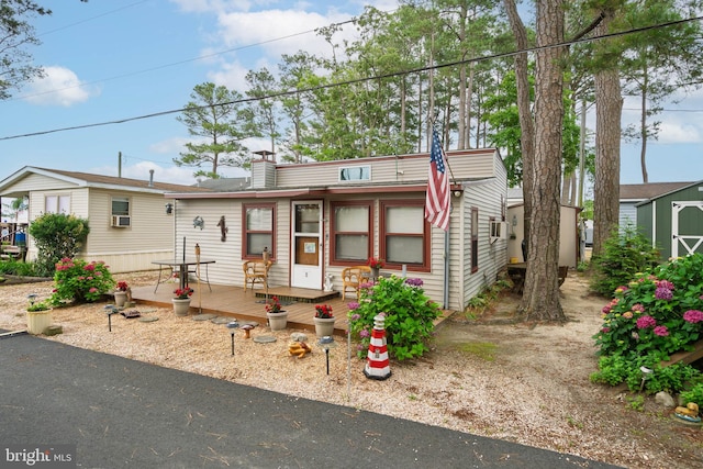 8 Clam Rd Unit 13891, Millsboro, DE 19966 - view of front of property featuring a wooden deck, a shed, and cooling unit