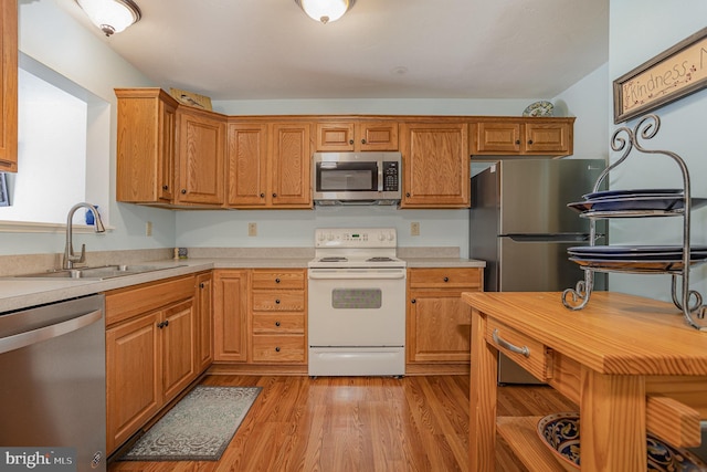 14 Cedarfield Dr, Gettysburg, PA 17325 - kitchen with appliances with stainless steel finishes, light countertops, light wood-style floors, and brown cabinetry