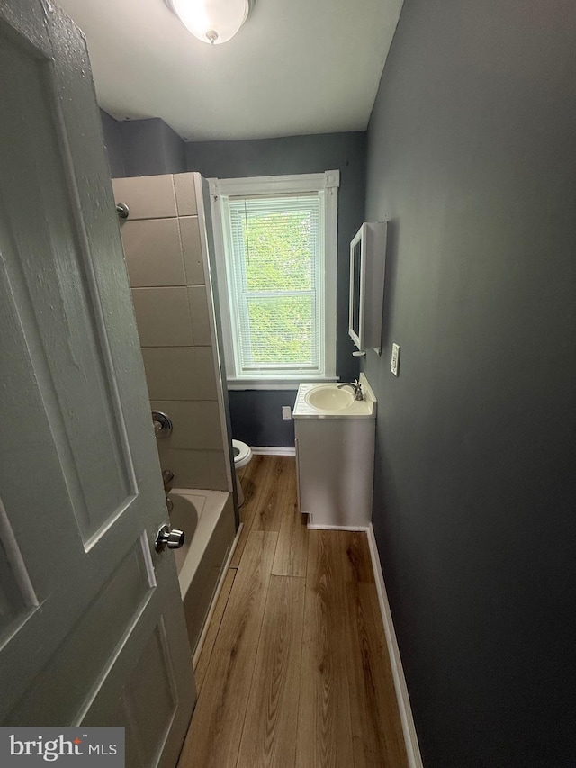 48 S 7th St, Darby, PA 19023 - bathroom featuring wood finished floors, vanity, toilet, baseboards, and  shower combination