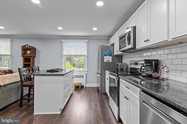 440 E Magnolia Dr, Morrisville, PA 19067 - kitchen featuring appliances with stainless steel finishes, radiator, healthy amount of natural light, a center island, and crown molding