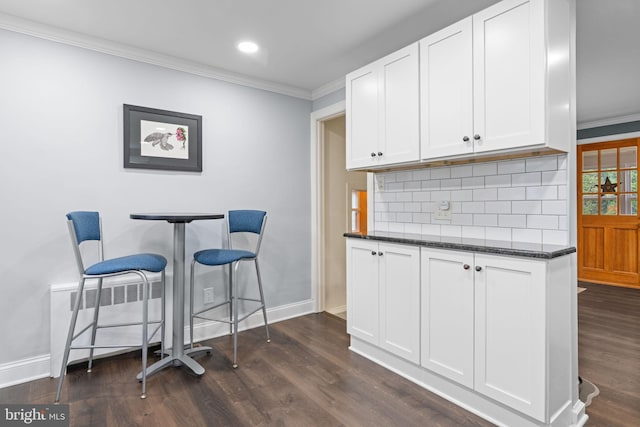 440 E Magnolia Dr, Morrisville, PA 19067 - kitchen featuring crown molding, decorative backsplash, white cabinetry, dark wood finished floors, and dark stone counters