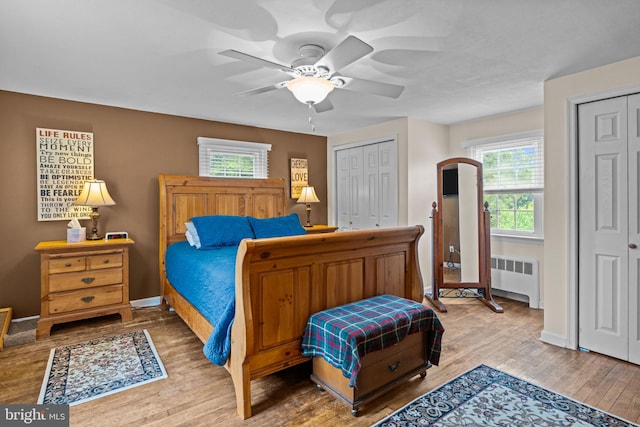 440 E Magnolia Dr, Morrisville, PA 19067 - bedroom featuring radiator heating unit, two closets, wood finished floors, and a ceiling fan