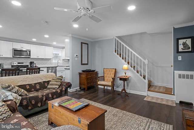 440 E Magnolia Dr, Morrisville, PA 19067 - living room with crown molding, dark wood finished floors, radiator heating unit, stairs, and ceiling fan