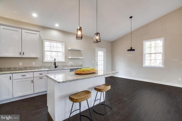 880 Campers Ln, Ruther Glen, VA 22546 - kitchen featuring dark wood-type flooring, a breakfast bar area, white cabinets, light stone counters, and a kitchen island