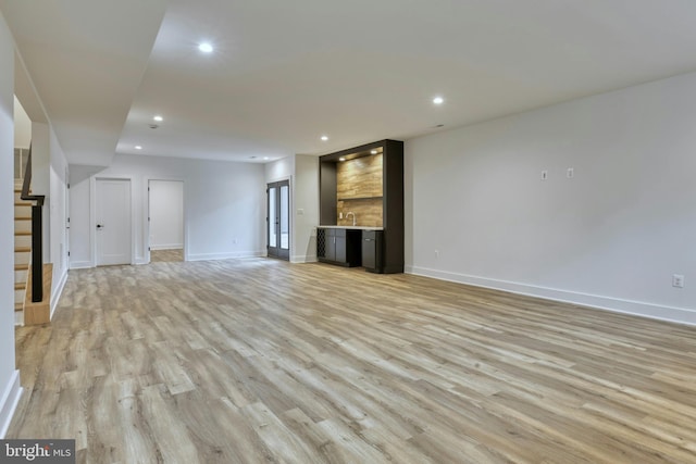 6400 26th St N, Arlington, VA 22207 - unfurnished living room with light wood finished floors, recessed lighting, bar, and stairs