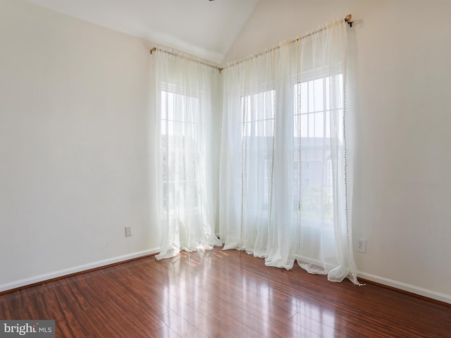 46598 Drysdale Ter Unit 302, Sterling, VA 20165 - spare room with healthy amount of natural light, vaulted ceiling, and wood finished floors