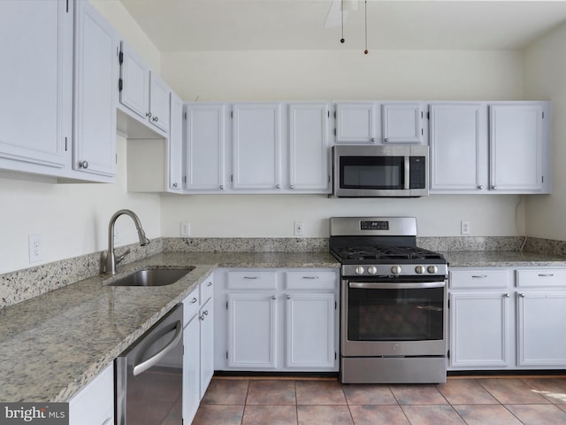 46598 Drysdale Ter Unit 302, Sterling, VA 20165 - kitchen featuring stainless steel appliances, white cabinetry, light stone counters, and tile patterned flooring