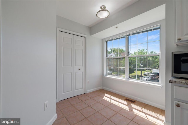 2222 Commissary Cir Unit 198, Odenton, MD 21113 - unfurnished dining area featuring plenty of natural light and light tile patterned floors