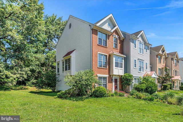 2222 Commissary Cir Unit 198, Odenton, MD 21113 - view of front facade with a front lawn, brick siding, and a residential view