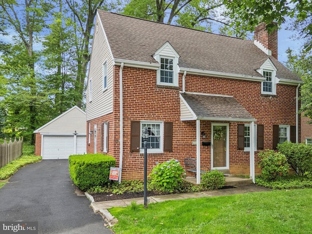515 Marks Rd, Oreland, PA 19075 - view of front of property featuring a chimney, an outdoor structure, brick siding, a detached garage, and a shingled roof