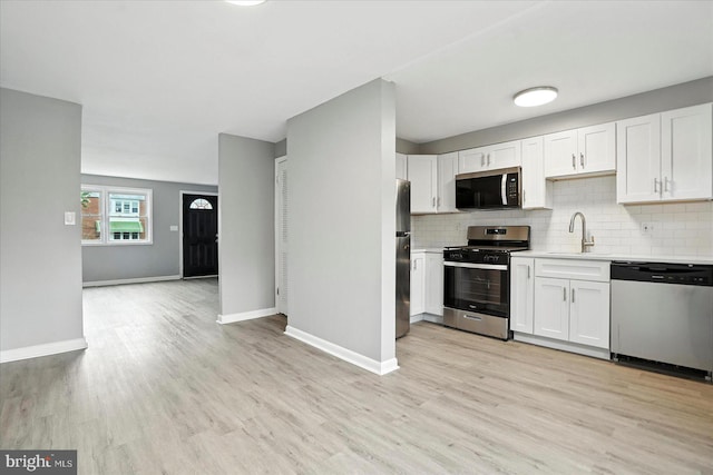 8206 Boundary, Baltimore, MD 21222 - kitchen with appliances with stainless steel finishes, light countertops, backsplash, and light wood-type flooring