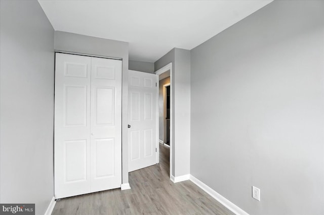 8206 Boundary, Baltimore, MD 21222 - unfurnished bedroom featuring light wood-style flooring and a closet