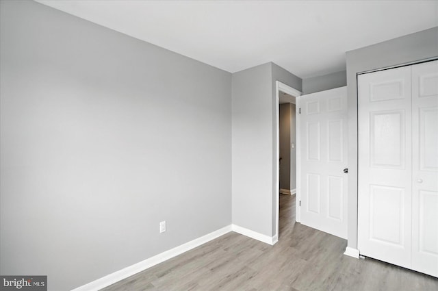 8206 Boundary, Baltimore, MD 21222 - unfurnished bedroom featuring light wood-style flooring and a closet