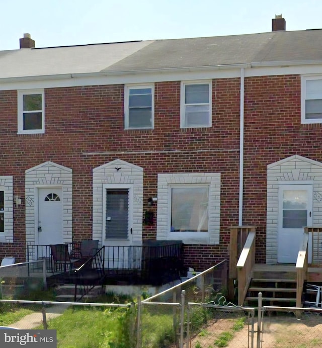 2134 Redthorn Rd, Middle River, MD 21220 - townhome / multi-family property featuring brick siding, a fenced front yard, and a chimney