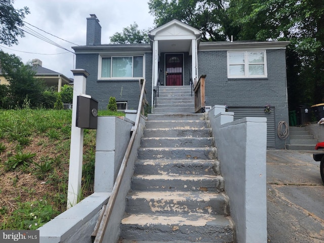 5702 Landover Rd, Hyattsville, MD 20784 - view of front of home featuring brick siding, a chimney, and stairway