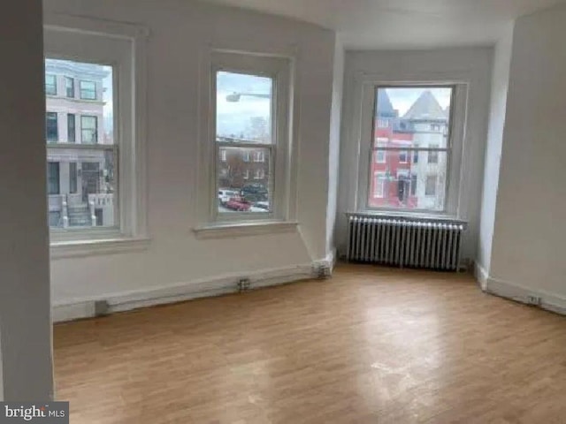 1720 1st St NW, Washington, DC 20001 - empty room featuring radiator heating unit and wood finished floors