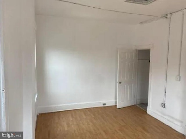 1720 1st St NW, Washington, DC 20001 - unfurnished bedroom with baseboards and wood finished floors