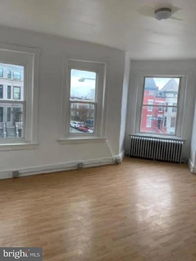 1720 1st St NW, Washington, DC 20001 - empty room with radiator heating unit and wood finished floors