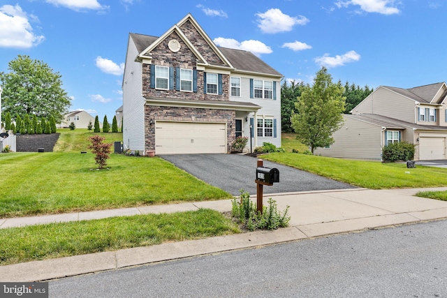 1010 Nugent Way, York, PA 17402 - view of front facade with stone siding, a garage, a front lawn, asphalt driveway, and cooling unit